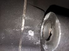 This is on the inside surface of the hole for the shaft. It was difficult to get a decent photo because there was very little room. You can see how it has worn away the metal of the inboard side of primary chain case.