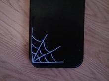 web on a wooden paddle