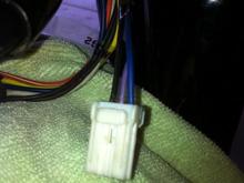 Turn signal connector. A 3-place Amp Multilock. I'm getting ready to de-pin this so I can pull the wiring up through the handlebars and get rid of those handlebar mounted turn signals. A safety pin works well for releasing the little tabs inside these things.