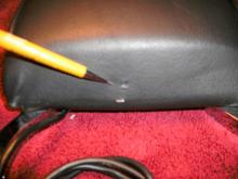 Two small holes on the bottom of the backrest