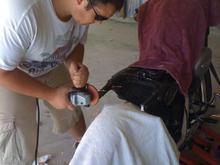 friend going back in and smoothing out the frame with a grinder.