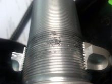 When using a Bridgeport end milling machine to remove the spring pre-load nut you can examine the dirt that was under the nut.  When running over the dirt the nut jams.
