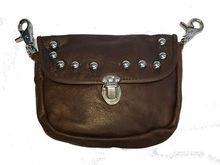 kind of like this. It clips on the belt loops and comes with a strap so she can convert it to a purse after riding.