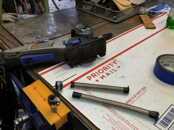 Cutting braided hose with tape to contain wires.