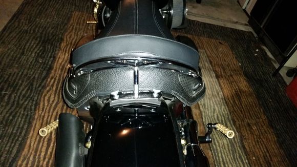 Aftermarket low rise grab rail back rest. Not an out of the box fix as a reviews stated, had to spread the grab rail and add a 1 inch threaded spacer to allow for real seat clearance.