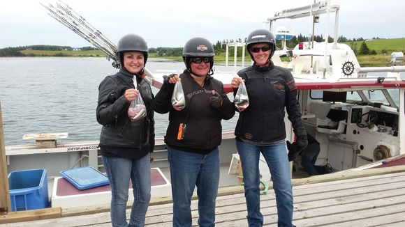 Day 9 - A fishing charter has just arrived back at the dock and a nice young lady from Manitoba offered her catch so the girls could take a picture.