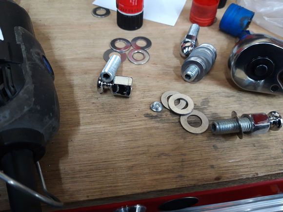 screws fitted and not fitted and showing the amount cut off by the washers in the center of the picture