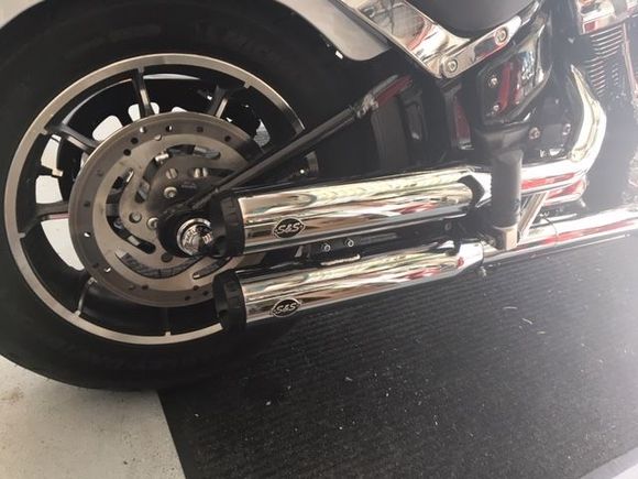 The S&S slip-on mufflers are 100% compliant and won't affect your warranty.  I like them because the shorter length makes checking the rear tire pressure easier.