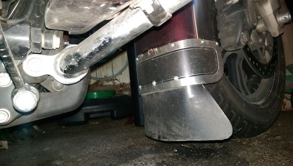 Mine, I curved a 5" piece of 5/8" x 1/16" stainless I had around to go on the inside, so the flap is sandwiched between it and the stock trim piece.  I forgot where I got the flap, it's for a rear fender.I trimmed it up a lot.  No, it's not normally quite that dirty, that was after driving three days  of crappy riding following the remnants of a hurricane.