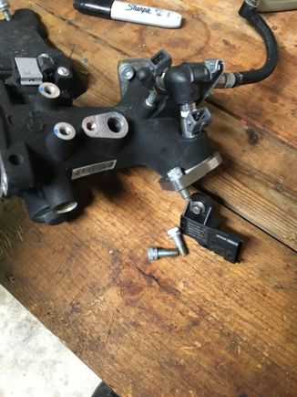 One bolt and the sensor comes off the throttle body. When removing the t body just gentle pull the flanges back and lift the assembly up and back through the right side and it comes right out.