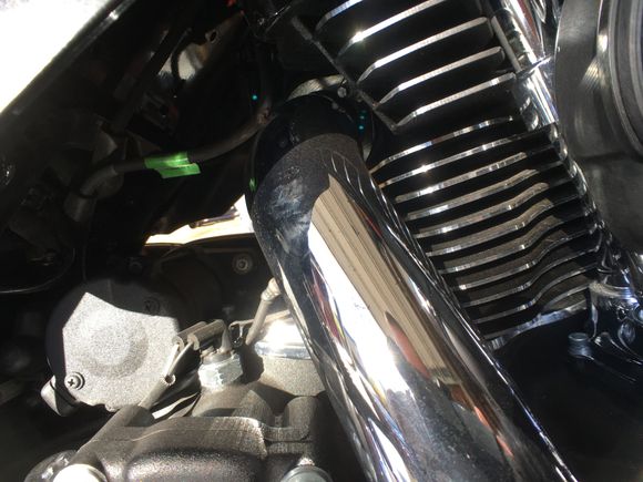 Spark plug wire resting on exhaust manifold.
