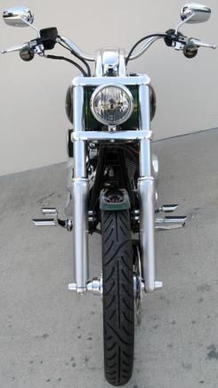 **Front End**
*H.D. Tinted turn signal lenses
*Painted turn signal reflector and internal housing flat black
*Screamin Eagle Dyna Signal Mounts
*Internal handlebar wiring
*Re-routed clutch cable
*H.D. 2006 Deuce headlight
*H.D. 2006 Sportster Custom headlight mount
*Wide Glide Triple Clamps
*Wide Glide 21" Wheel
*Avon Venom 90/90B-21 tire
*Kuryakyn Front Axle Nut Covers
*H.D. Chrome Tapered Front Wheel Spacer Kit