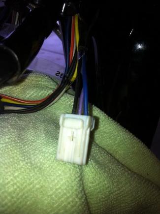 Turn signal connector. A 3-place Amp Multilock. I'm getting ready to de-pin this so I can pull the wiring up through the handlebars and get rid of those handlebar mounted turn signals. A safety pin works well for releasing the little tabs inside these things.