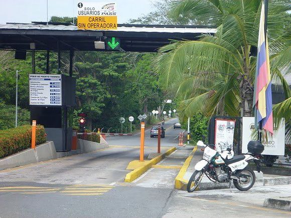 In columbia the tolls are free for motorcycles and they have their own lane.  Their lane is marked by the two below lines on the curb on the right hand side.
