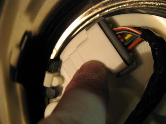 Gently spread two ears on ECM/Speedo connector and slide off.