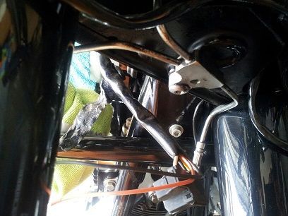 view of where the brake line connects to the frame under the nacelle