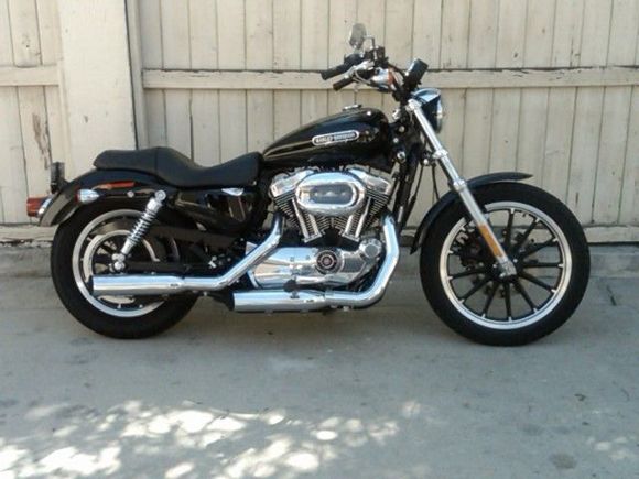 XL1200L Low 2007
Before the Sundowner seat, and tallest Sissy bar from HD were put on.
It has the high flow intake, H&N air filter, and Screaming Eagle exhaust, and has been remapped for the increased air flow. I added a Tachometer as well.  ;^)