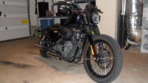 2009 1200N, Black Bullet style Headlight, flat black heat shields and A/C, flipped mirrors, relocated turn signals w/ smoked lenses, drilled stock baffles