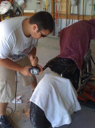 friend going back in and smoothing out the frame with a grinder.