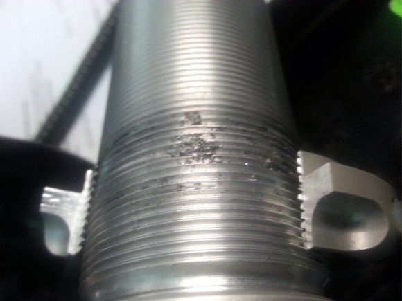 When using a Bridgeport end milling machine to remove the spring pre-load nut you can examine the dirt that was under the nut.  When running over the dirt the nut jams.