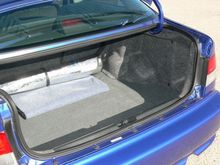 Trunk, with rear seat backs in "up" position.  I use the blanket to protect trunk when carrying stuff.  The rolled up "Sun Shade" is a genuine Honda part, and fits the windshield perfectly.