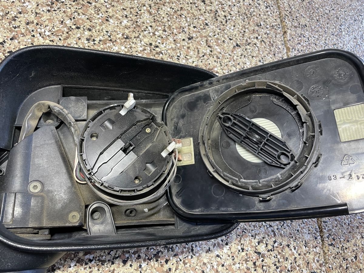 Top half of the mirror motor stayed on the glass.  What holds it to the base are those two white plastic connectors... so that is the point of failure