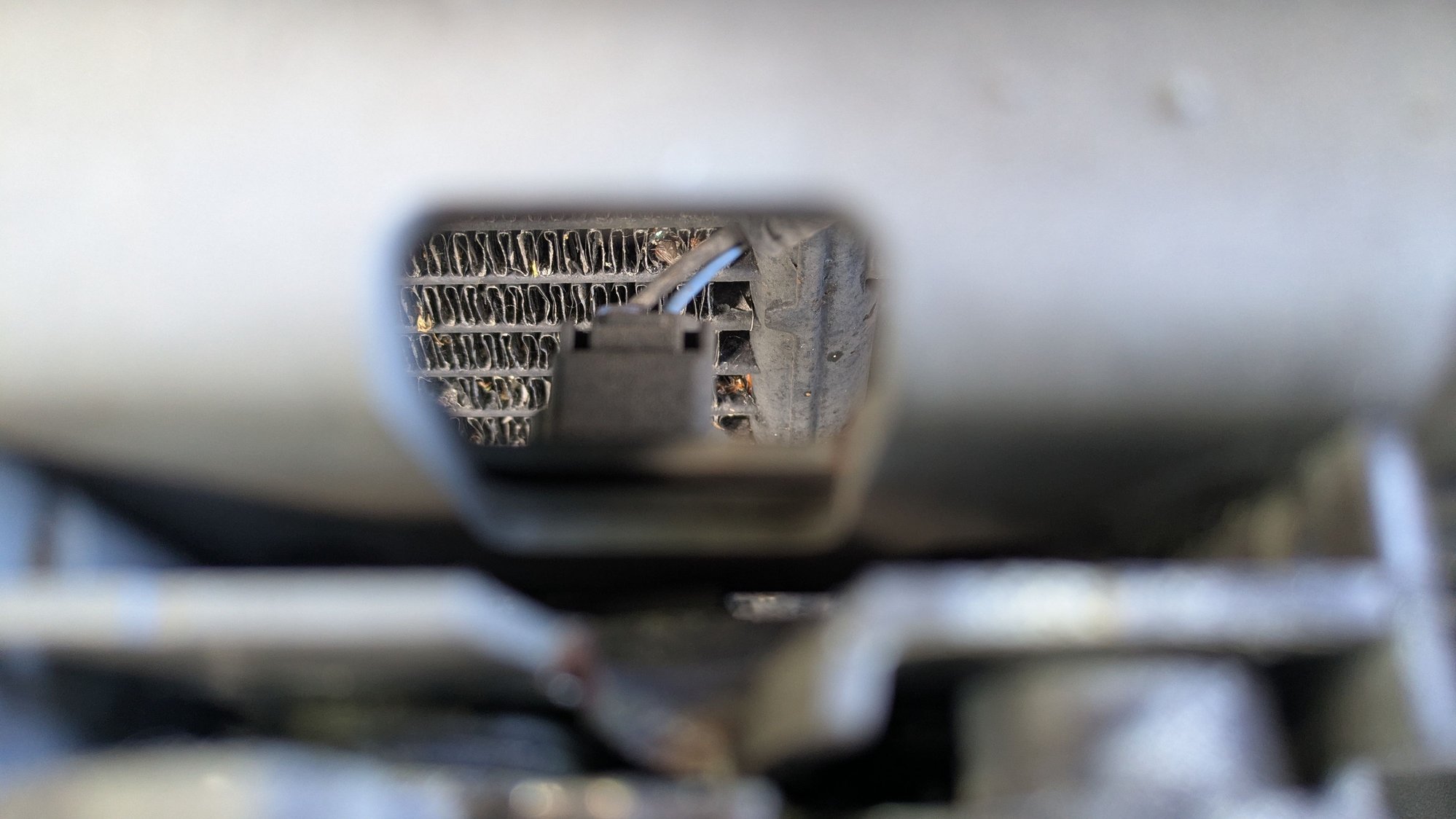 Electrical connector seen through the hole in back of the latch