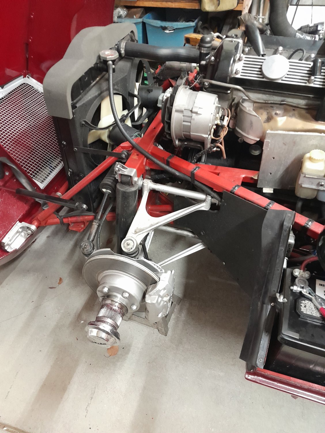 Off side front wheel removed and front of car on jack stands so I can lie underneath and turn the crankshaft for timing purposes