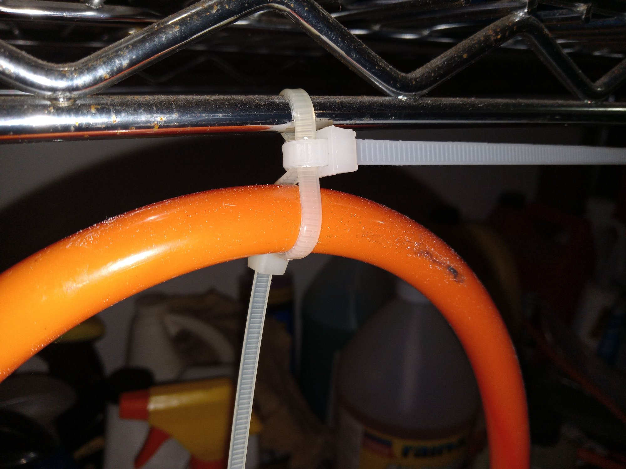 2nd tie-wrap attached between the hose and the support, then tightened firmly. At this time, BOTH tie-wraps can be snugged up.