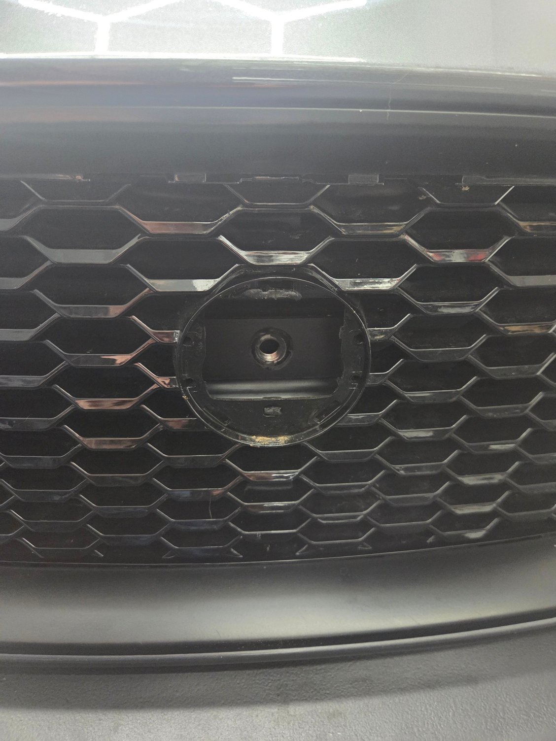 I made the emblem removable and installed a spot for a tow hook behind it.