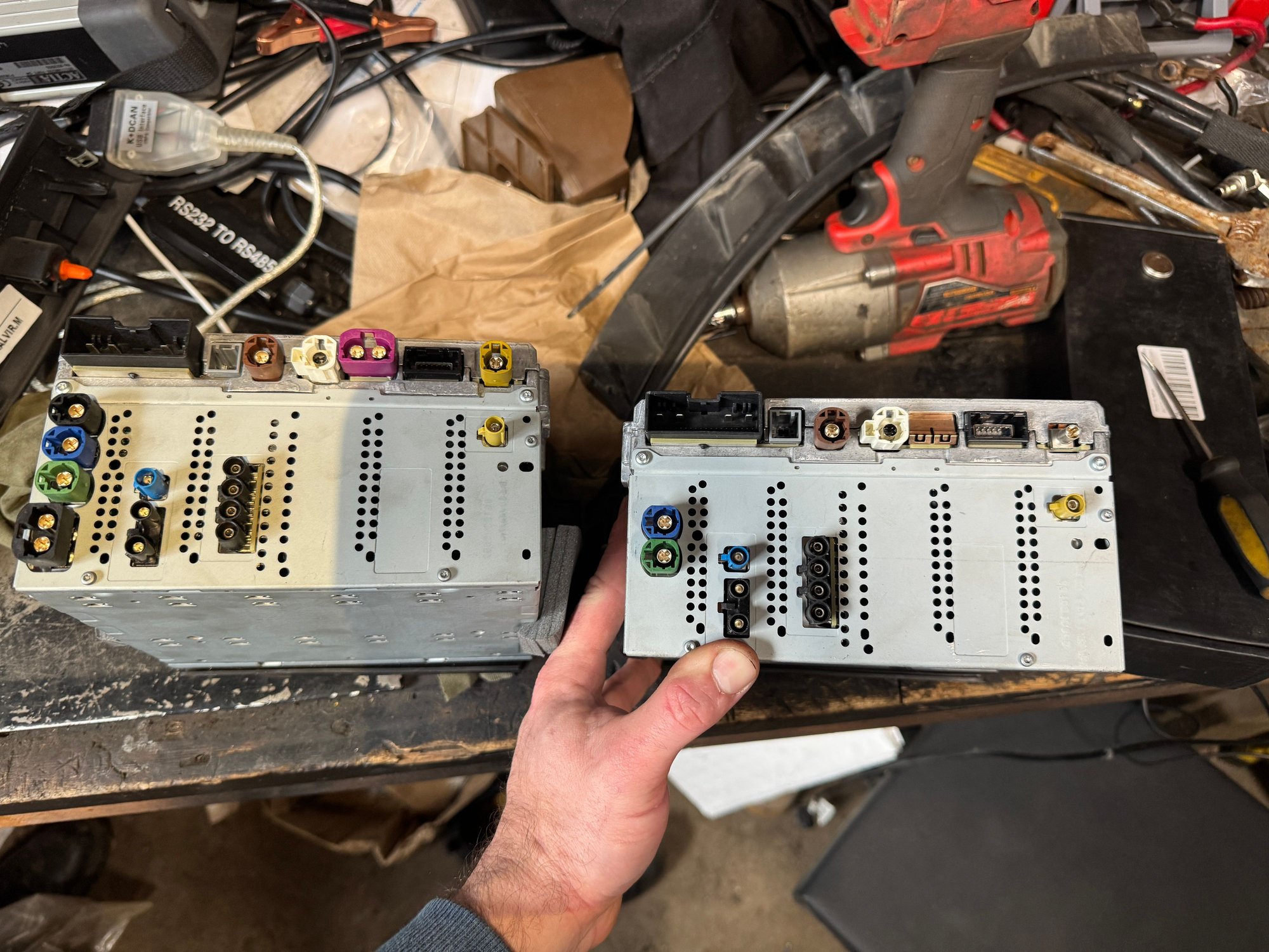 Old unit on the left, newer one on the right. One on the right is missing the purple plug on top. Also doesn't have the black dual plug on the bottom left, however my car does not have a harness for that plug anyway.