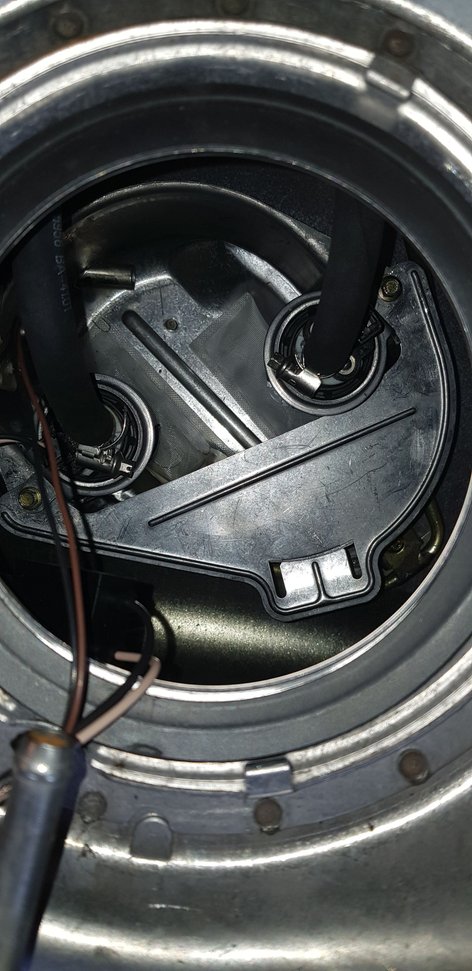 If you have an XKR and swapping both pumps, just do one at the time. I unscrewed both at the same time and the splashguard fell off and was a pain to get back in the right possioton again. It is mounted with the same screws as the pumps. By just unscrewing one at the time the plate will stay put.