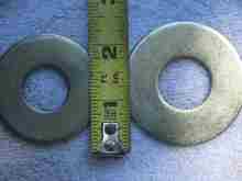 2 different size washers, big ones go against the bottom of the spring pan