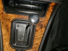 The original is black leather with a silver stripe