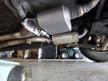 The bypass, if left in this state, will dump the raw exhaust on the back of the muffler. I may not be able to find a downpipe short enough to fit, so I'll probably just weld one up (or two I should say). You can see the stock exhaust setup in the background.