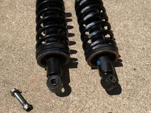 The spring is captured by the shock, so no worries of a
sudden release of energy when you pull the unit off of the car.  