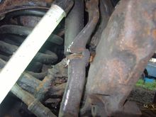 I had to cut through the Steering Arm in order to get the Broken Caliper Bolt out