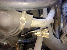 Loose spades. Drivers side front of motor looking back. Snoot on right edge of frame. Wire route back under right side intake then to 4 beige wires at loom behind throttle capstan.