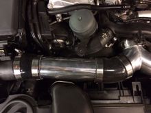 The two 45 degree silicone couplers have about 1.5" of the ends cut off to clean up excess material and show off the polished pipes.