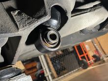 Bottom of shock protruding through the suspension arm.
