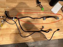 The wiring harness with part that's too short circled in red.