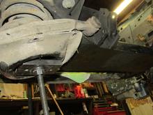 Bottom side: a 1/2" thick flatbar drilled large enough to allow the rod freedom-you don't want it to bind.  The bar acts to level the load. Very valuable when reinstalling.