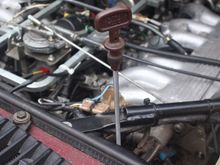 Transmission Fluid Dipstick being pulled out to Check the Level of the ATF