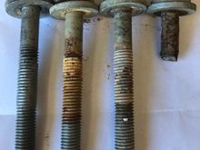 This bolt is more fully threaded, and not a dog point bolts, as the sheared threads are clearly visible at the top of the bolt.