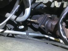 Here you see the top of the l/h catalytic converter, the plastic tube between MAF sensor and inlet housing removed for axccess.. oxy sensor on its way out.. The nuts holding the cat to the exhaust manifold are, when they are new, pinched a bit i norder to not back of and become loose.. Be aware, they tend to cut in to the threads when backed off..