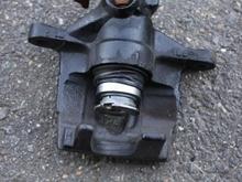 Starting to remove the piston.  Rotate till the piston will not come out any more.  Then pull the piston straight out.  If you are even at a slight angle, it will fight you the whole way.  You see that the boot will stretch to fit over the piston.