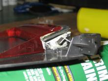 Side view of added angle to hold assembly to rear window.