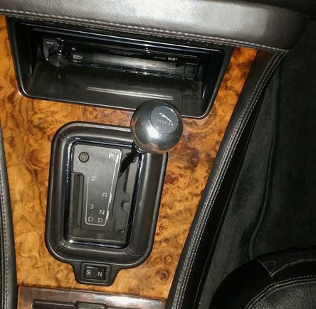The original is black leather with a silver stripe