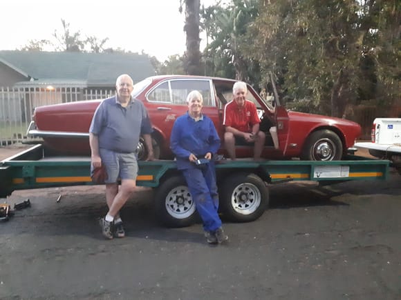 Very weary but happily loaded up. I am sitting in the car, my brother sitting on the mudguard, and our friend happy to see something happening with his old car.