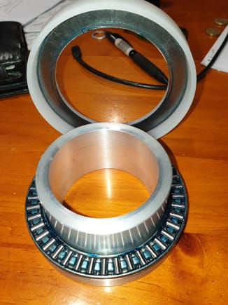 Needle roller thrust bearing with spring spacer/debris shield.